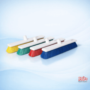 An 18 inch HACCP color-coded hygiene sweeping brush head in a professional setting